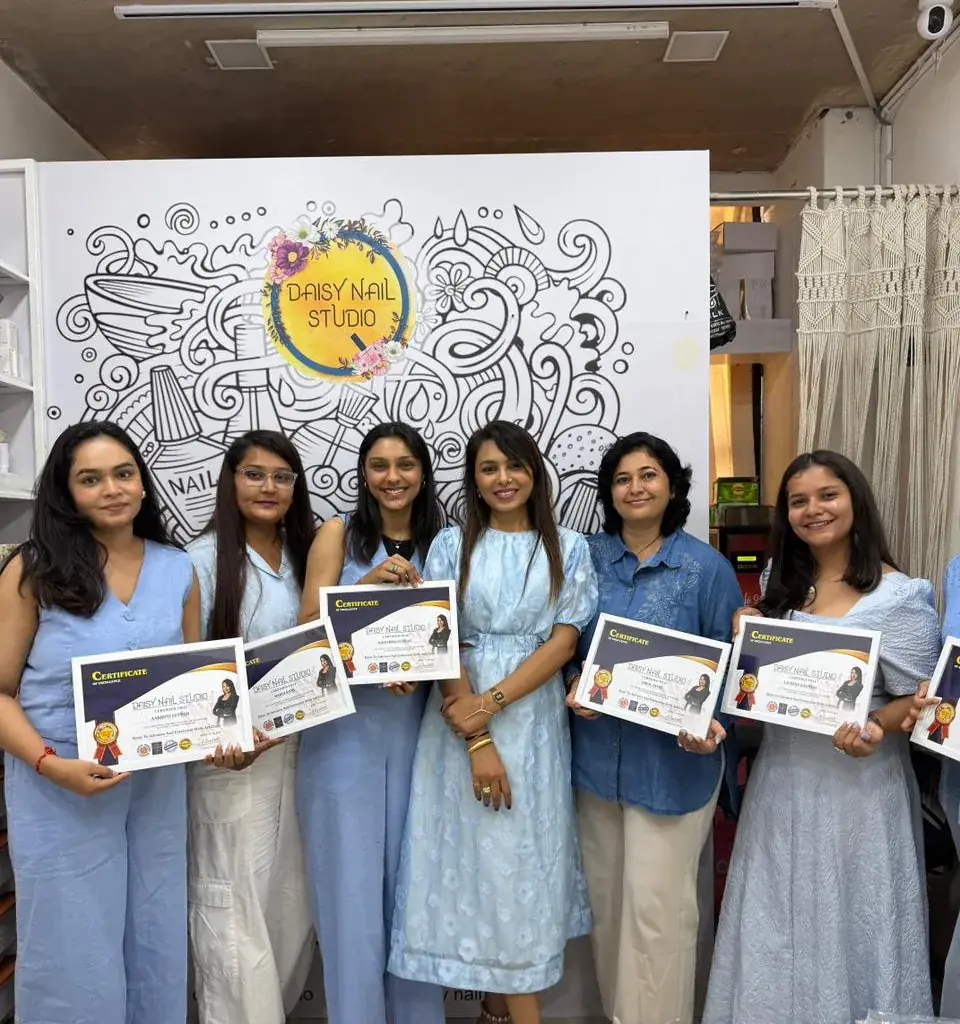 A Daisy Nail Academy group holding their Certificates of Excellence