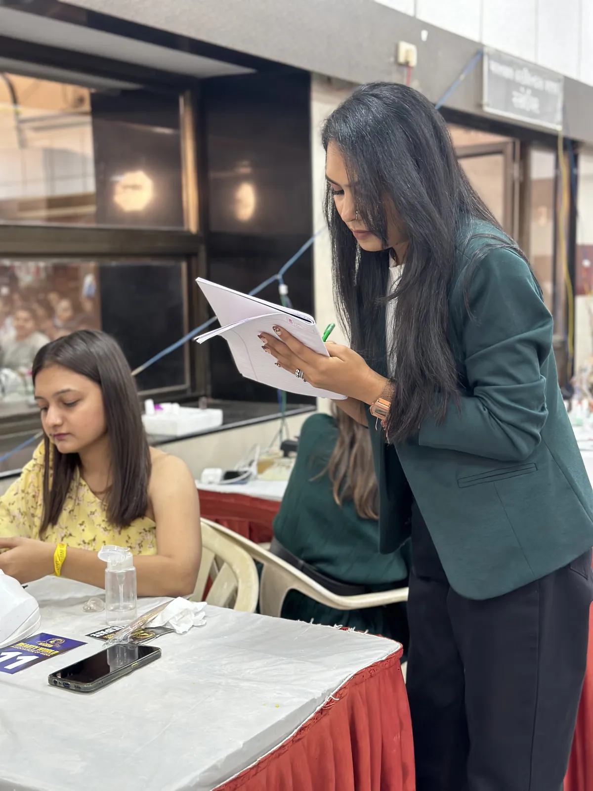 Bhumika Panchal evaluating manicure technique at a live nail competition