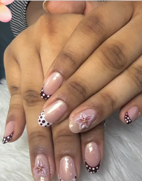 Hand-painted polka-dot French tips with sculpted 3D plumeria flowers