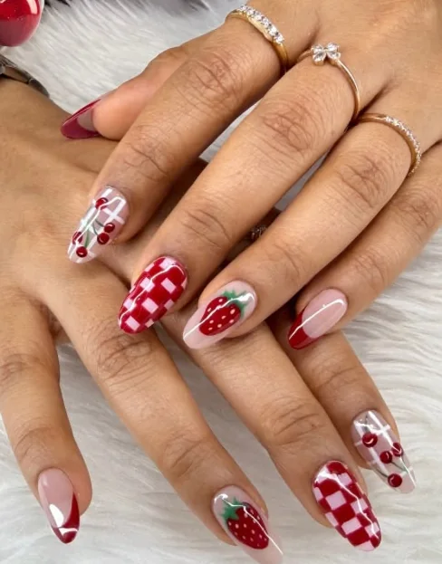 Red gingham extensions with painted strawberries and glossy tips