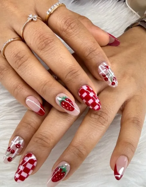Acrylic almond extensions painted with red gingham check and strawberries